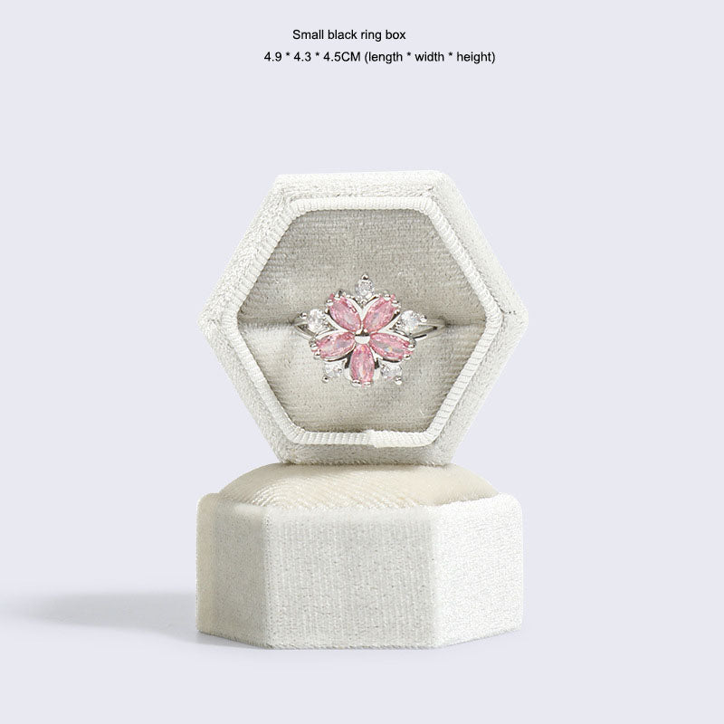 Hexagonal velvet ring jewellery box, light gray, open with pink flower ring and lid