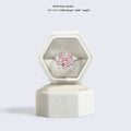 Hexagonal velvet ring jewellery box, light gray, open with pink flower ring and lid
