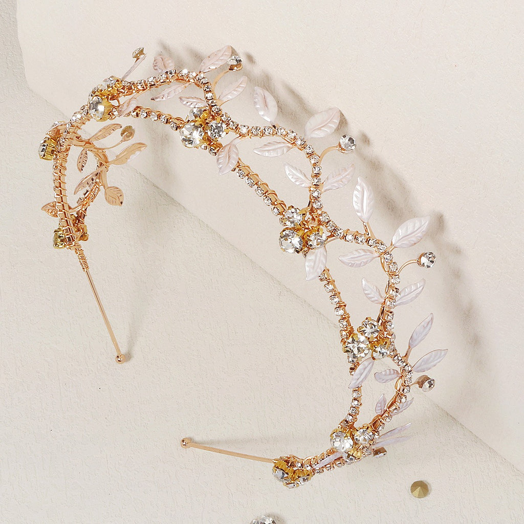 Gold rhinestone leaf bride headband with curved frame and two hairpin posts