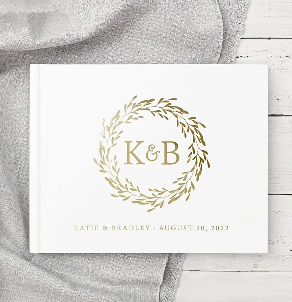 Personalized wedding guest book with gold monogram "K&B" in wreath and Aug 20, 2022