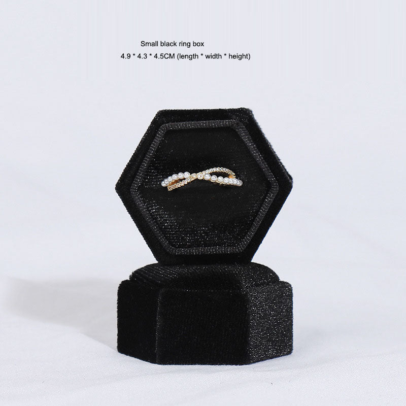 Hexagonal velvet ring jewellery box, black, open with small cross ring