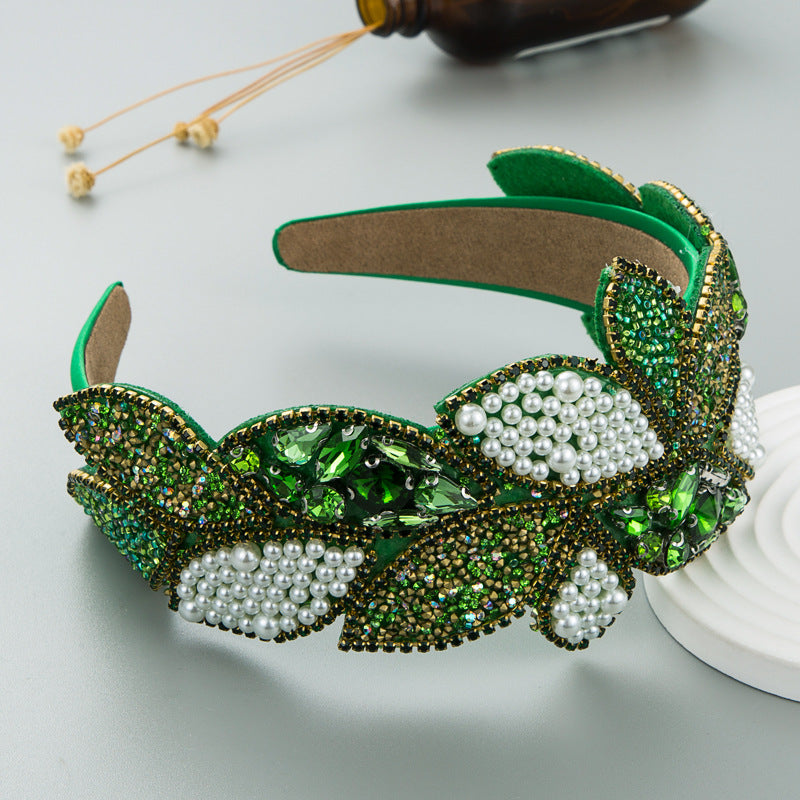 Wide pearl and rhinestone headband with green sparkle flowers and pearl clusters