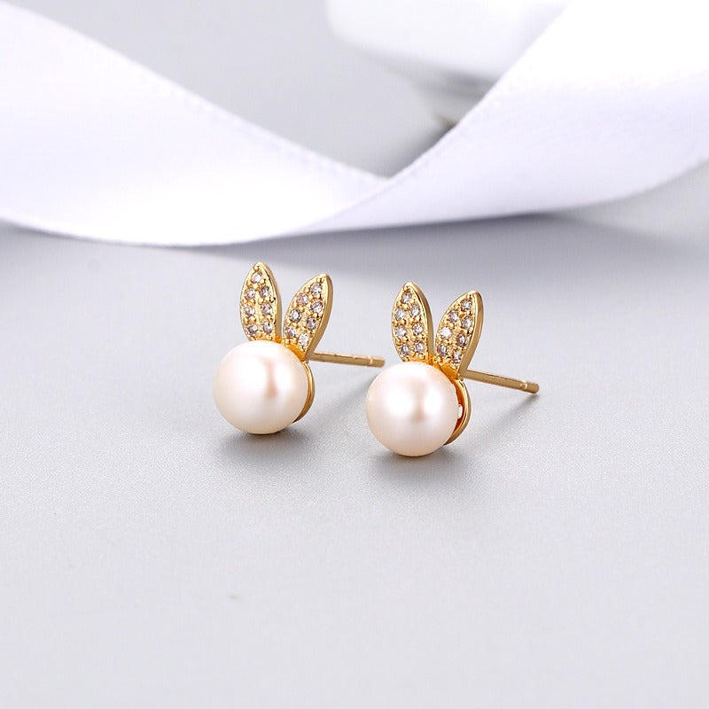 Gold-tone rabbit zircon stud earrings with round white pearl and crystal accents
