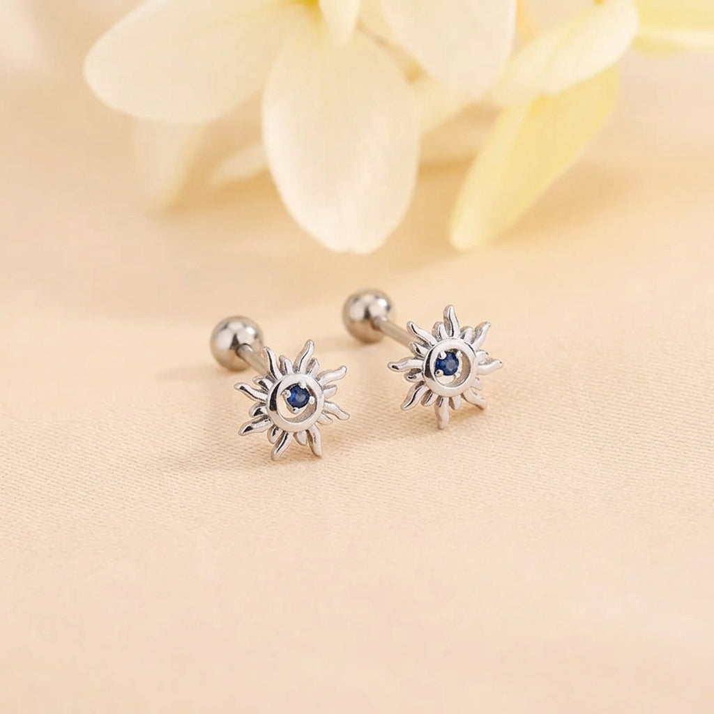 Sunburst huggie hoop earrings with blue center crystal and silver-tone finish