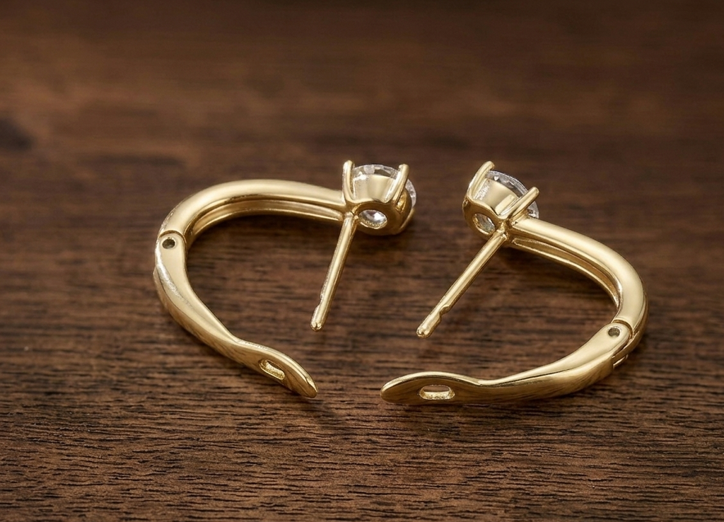 Light gold hoop earrings with white solitaire stones and stud posts