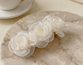 Champagne satin rose clip-on barrette with three sheer-textured rosettes.