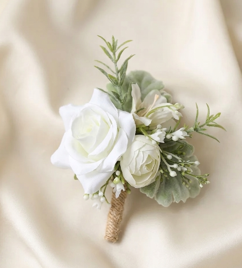 Close-up white rose boutonniere with green leaves and small buds, burlap-wrapped stem