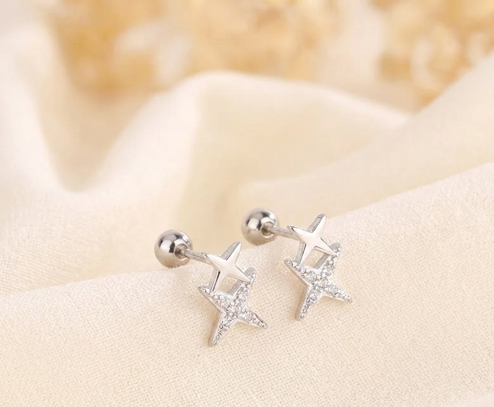 Star huggie hoop earrings with clear crystal stars and silver-tone settings