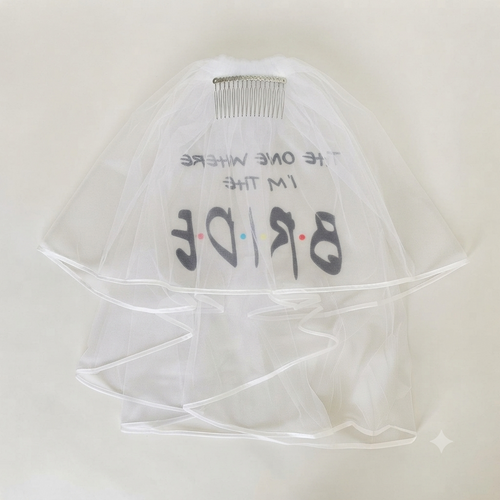 White tulle bride veil with hair comb and “Bride” lettering