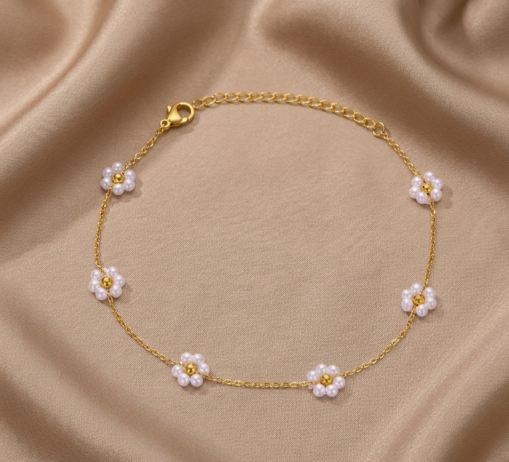 Gold chain pearl bracelet with clustered white pearl accents on the front