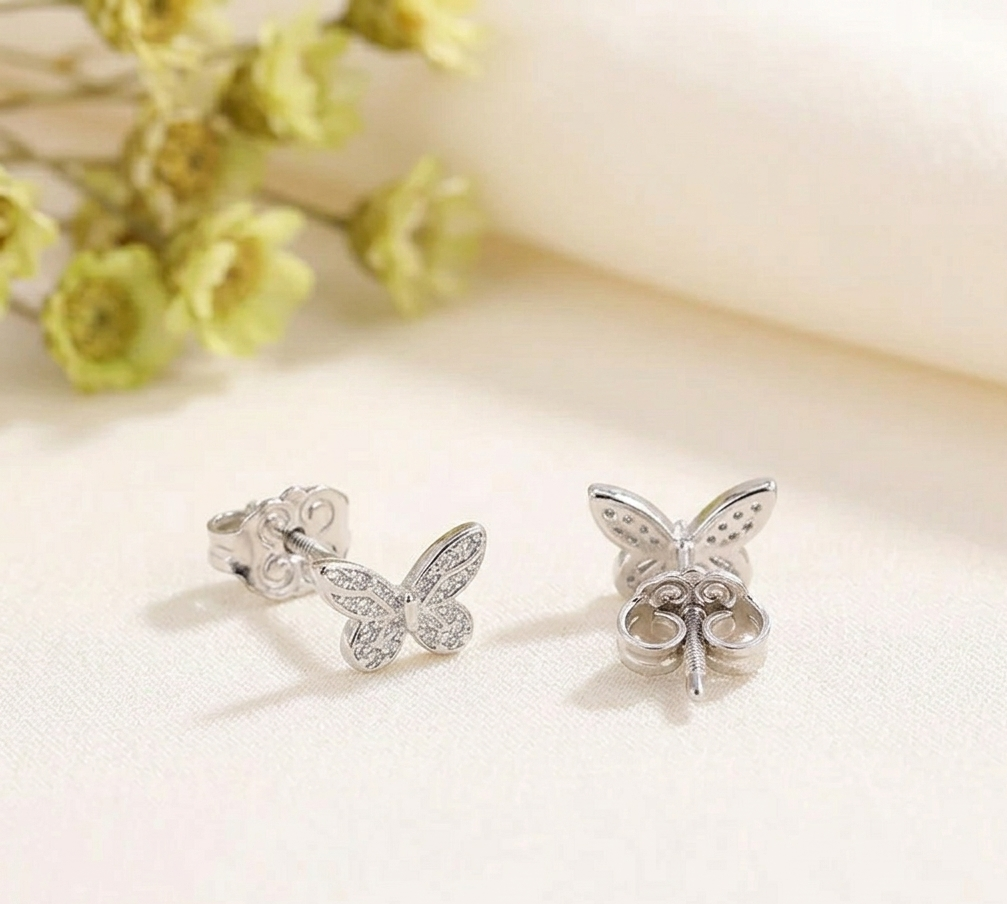 Butterfly huggie hoop earrings with crystal wing details in silver-tone