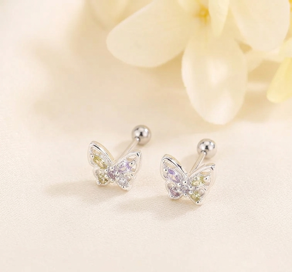 Small silver-tone huggie hoop earrings with heart-shaped crystal design