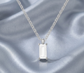 Silver-tone statement necklace with baguette drop crystal pendant and prong setting