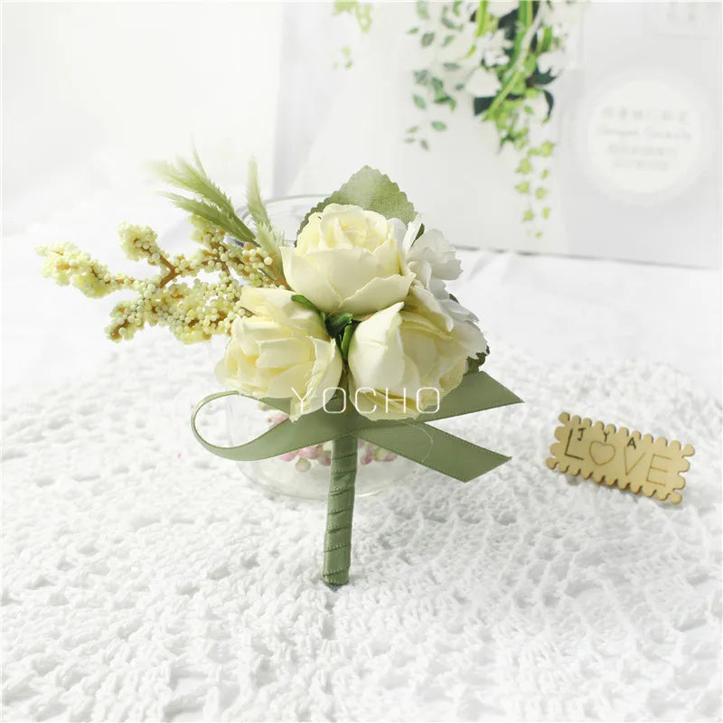 Silk botanical groom's lapel pin with pale-white roses, green ribbon, and burlap stem