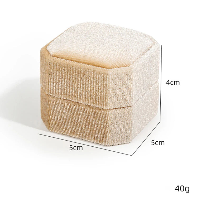 Beige octagonal velvet ring box, closed view with size and weight markings