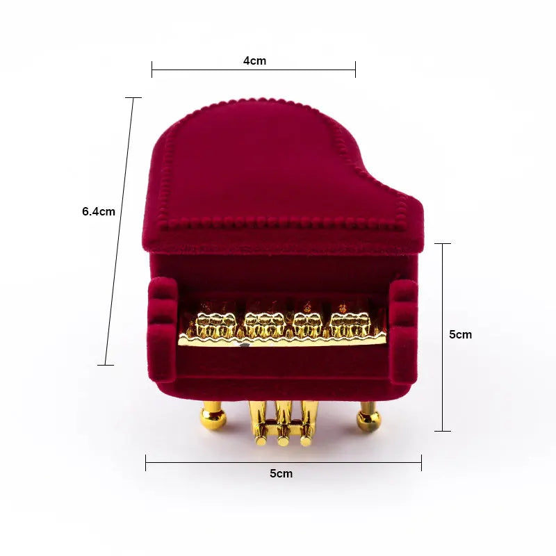 Piano-shaped burgundy velvet ring box front view with gold key detail and base dimensions