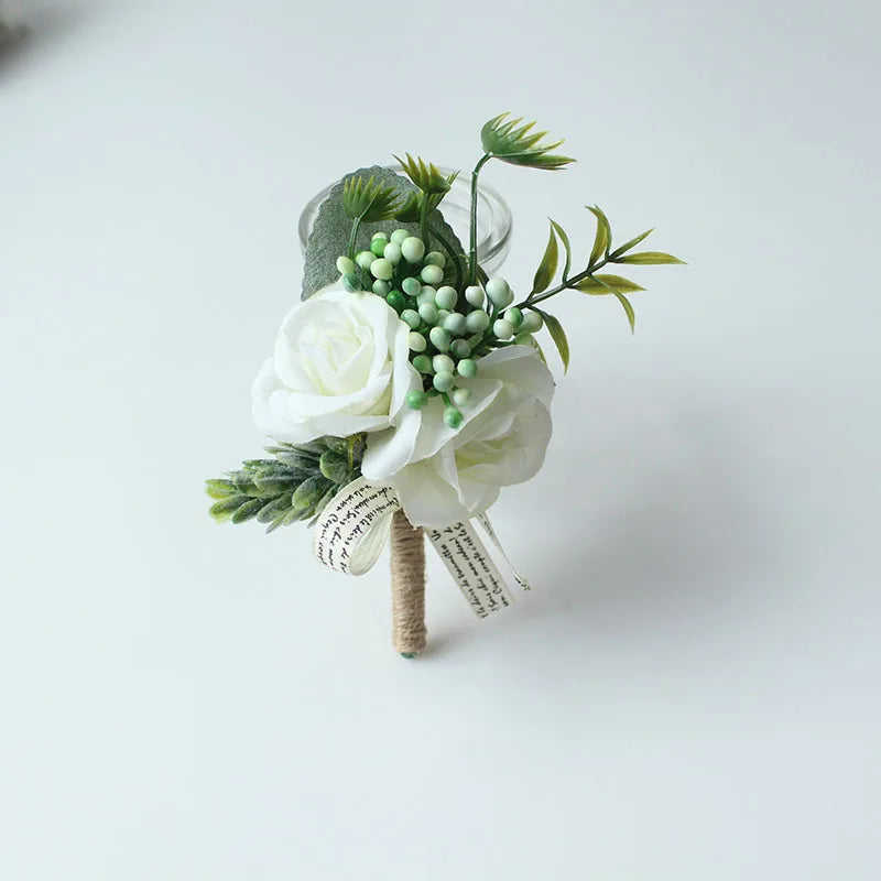 Silk botanical groom's lapel pin with white roses, green berries, and leaf accents