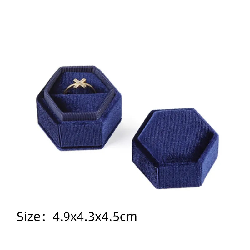 Navy octagonal velvet ring box set with open lid and size text