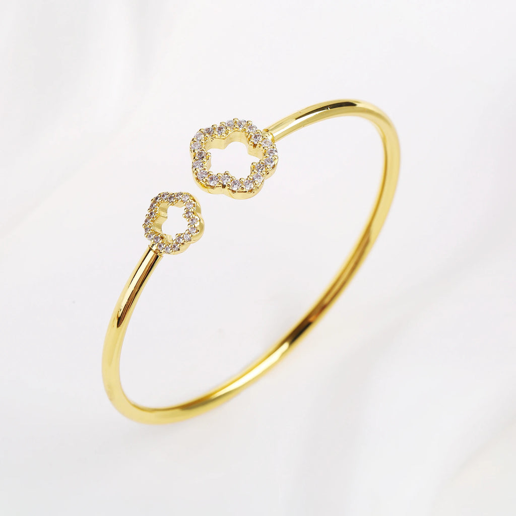 Gold open cuff bangle with zirconia clover accents