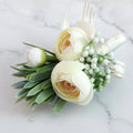 Ivory and green peony boutonniere with small white berries and ribbon tie