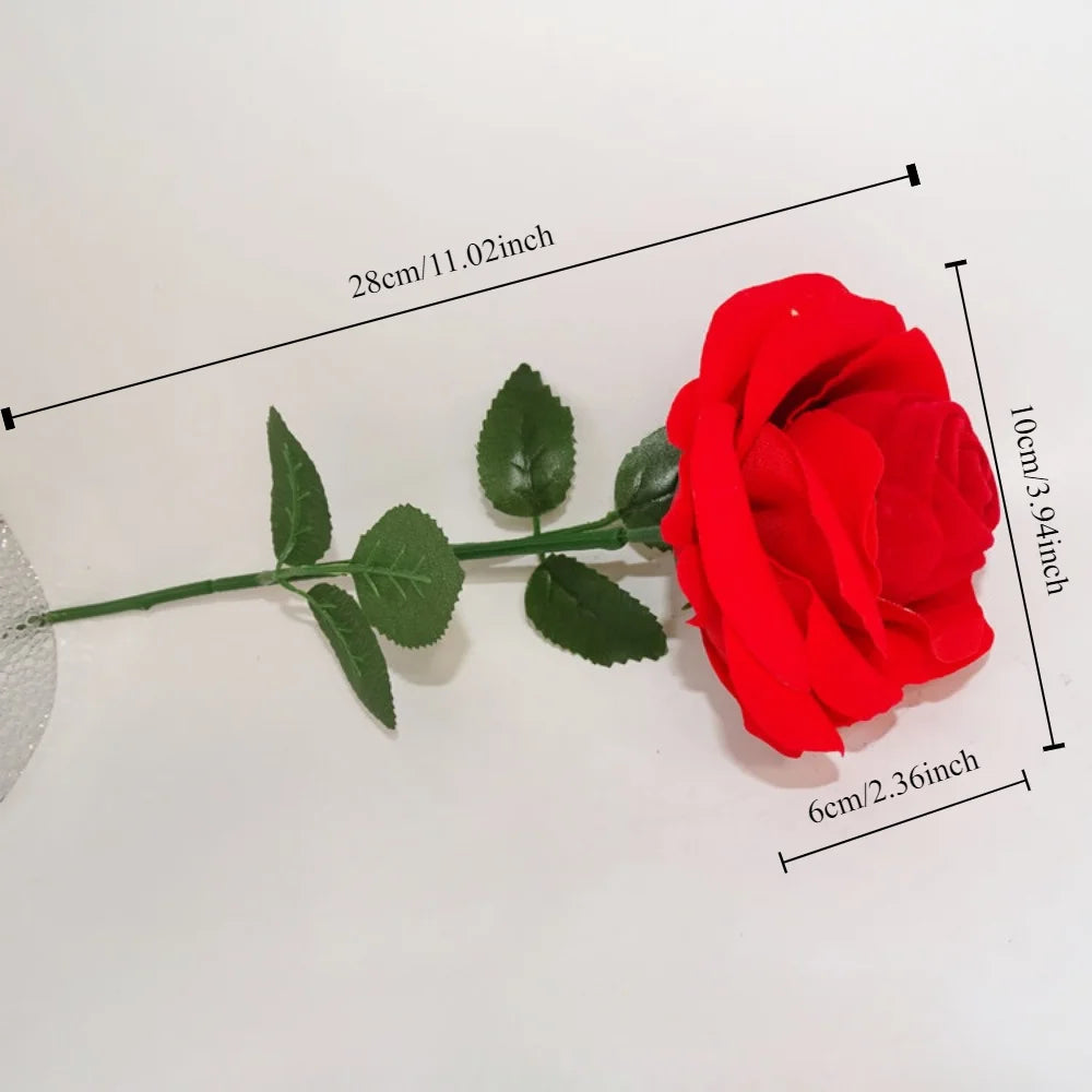 Close-up red velvet rose proposal ring box with green leaf sprig