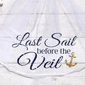 White veil with navy script 'Last Sail before the Veil' and gold anchor