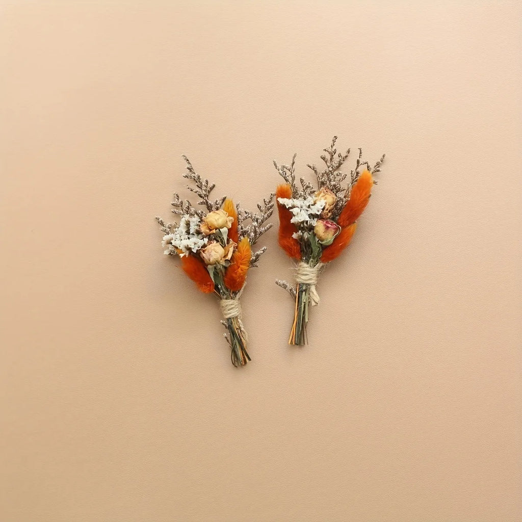 Set of 2 dried flower boutonnieres with orange blooms, white sprigs, and bundled stems