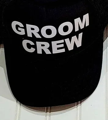 Black mesh trucker cap with bold white text: GROOM CREW