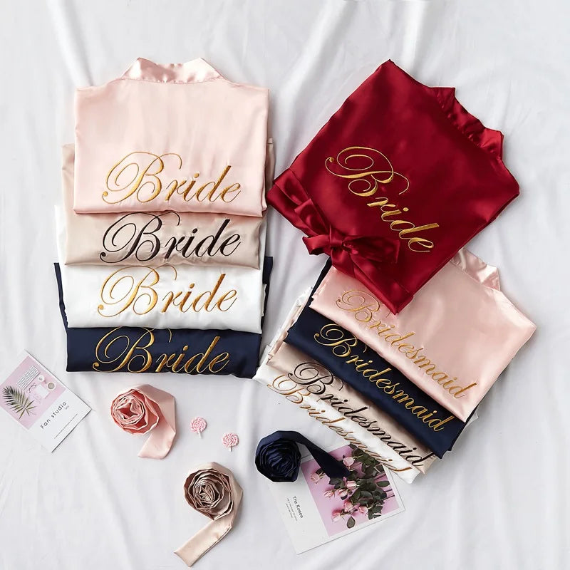 Bride and Bridesmaid satin robes, blush, red, and navy, each with gold embroidery