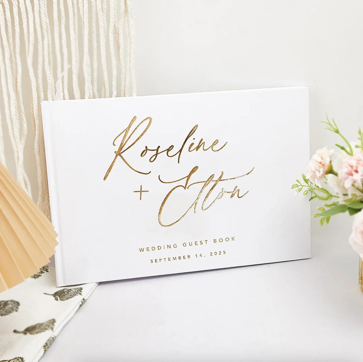 Personalized wedding guest book with gold script "Roseline + Alton" and Sep 14, 2025