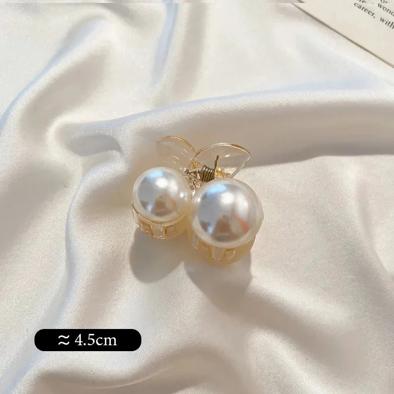 Small pearl bead hair claw clip with two large faux pearls and clear prongs