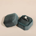 Teal octagonal velvet ring box open with a pearl ring inside