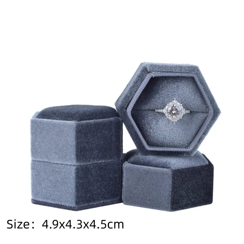 Gray octagonal velvet ring box set with open lid and size text