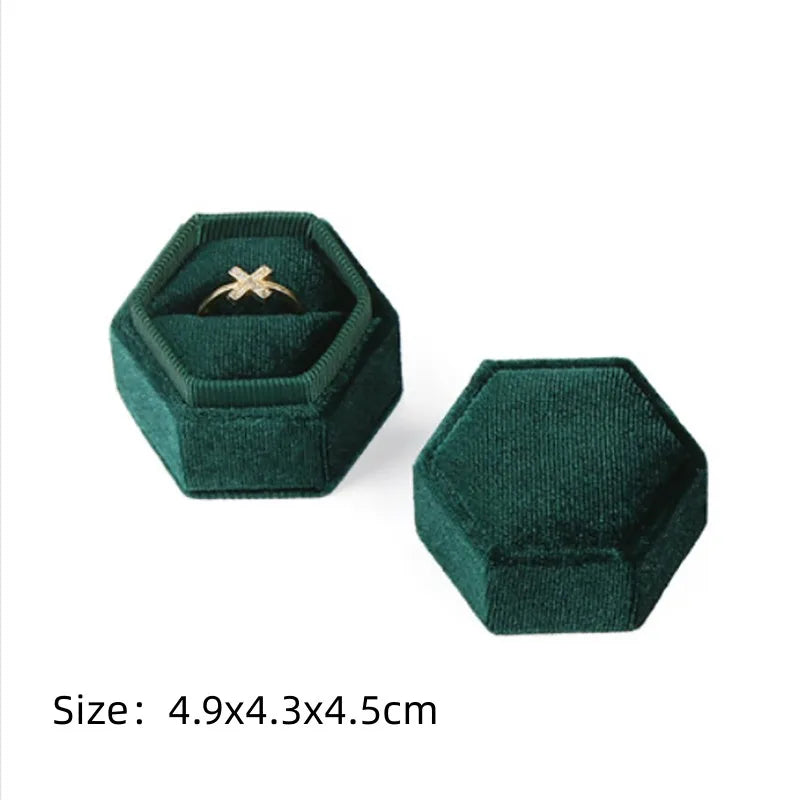 Green octagonal velvet ring box set with open lid and size text