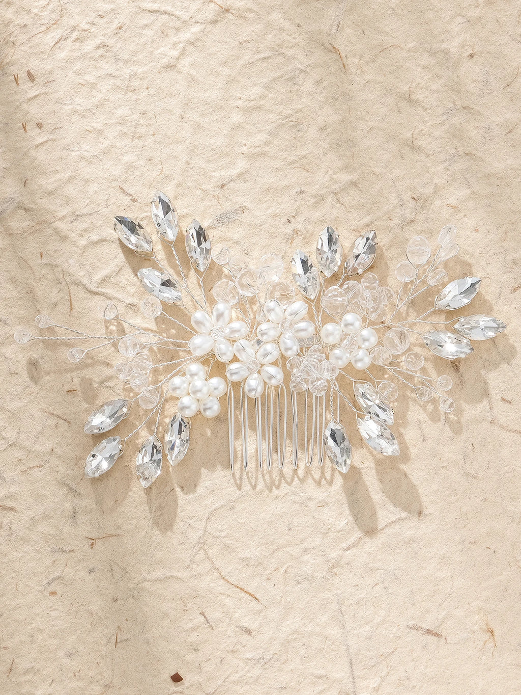 Bridal hair comb featuring pearl clusters, crystal leaf branches, and clear prongs