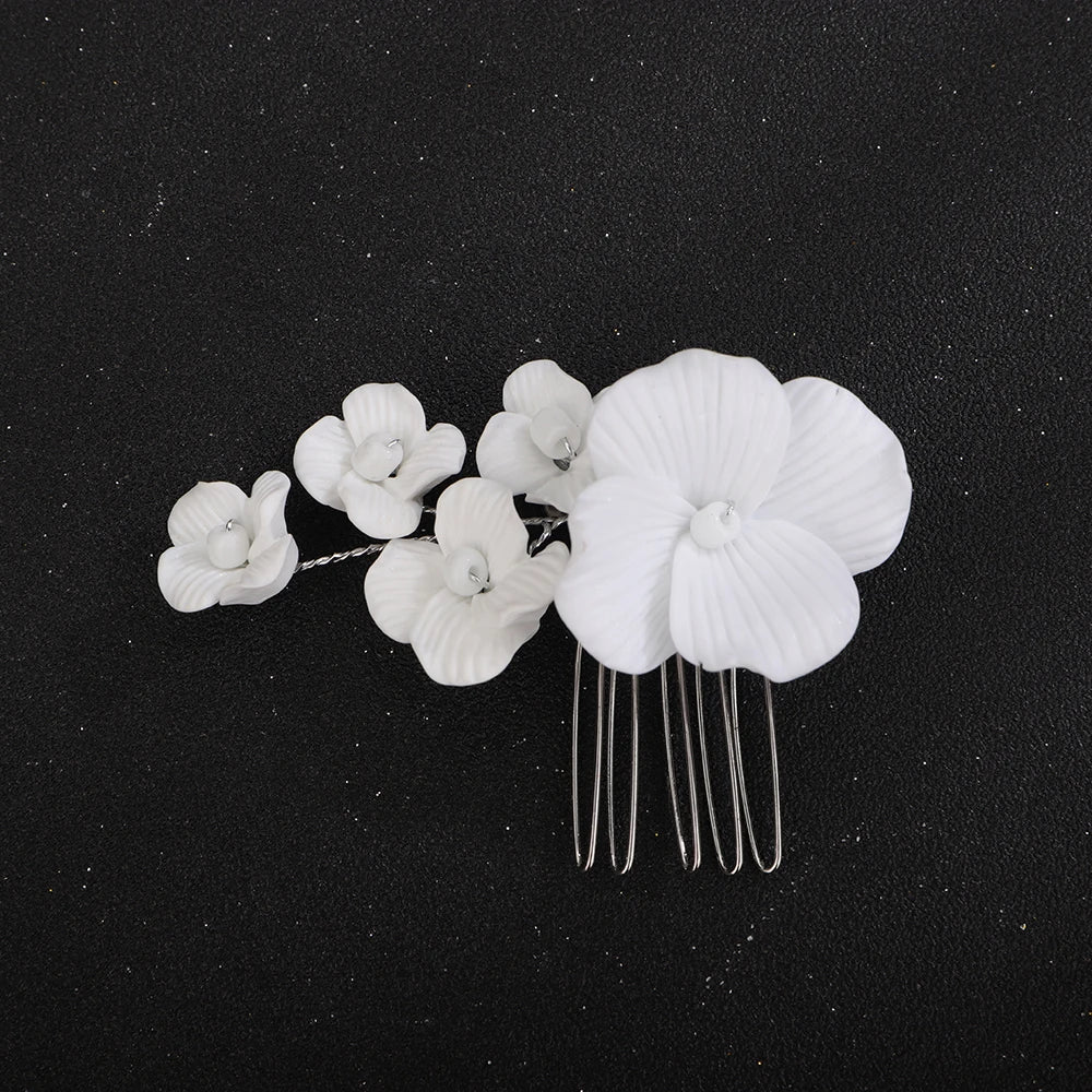 White orchid blossom bridal hair comb with rose-gold prongs and large front flower