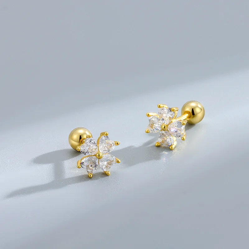 Gold-tone sparkle stud earrings with white starburst floral clusters