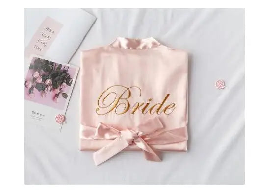Blush satin robe with embroidered “Bride” and front waist bow, plus included card