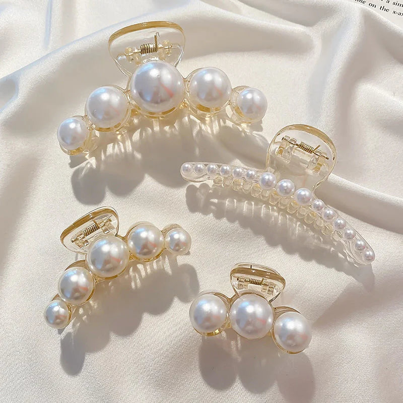Assorted pearl bead hair claw clips with golden-toned frames and clear prongs