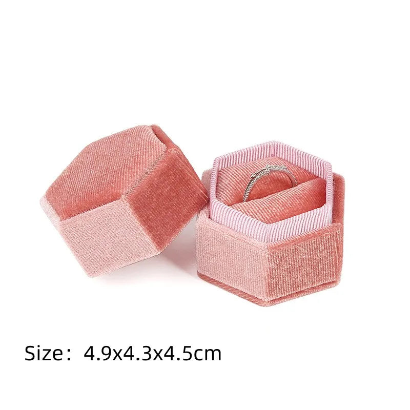 Pink octagonal velvet ring box set, open lid with ring and size text