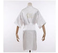 White satin robe with embroidered “Maid of Honor” on back and tied waist belt