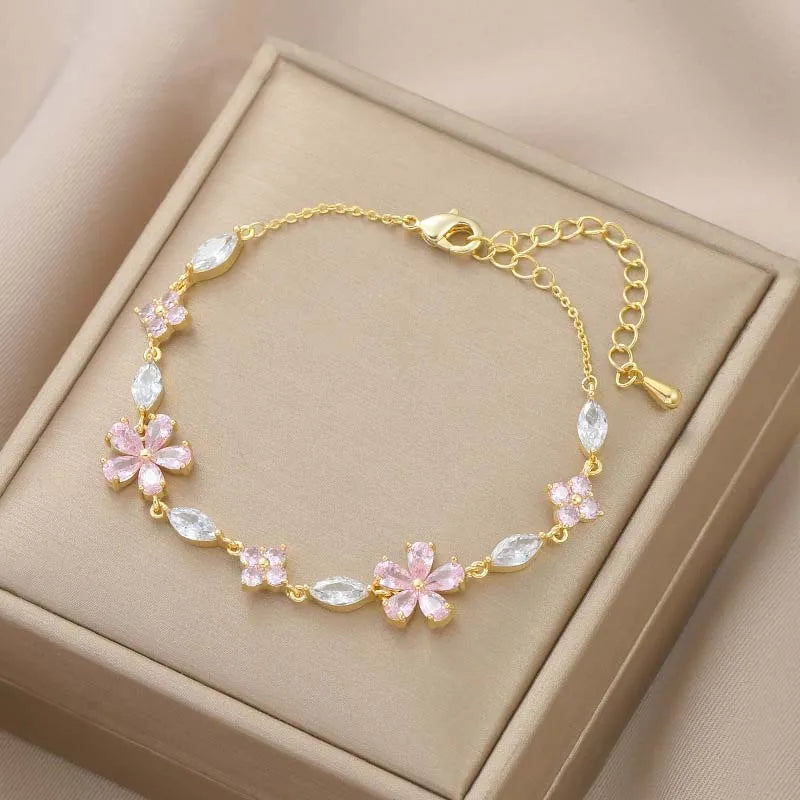 Gold-tone crystal flower bracelet with pink petals and clear teardrop stones
