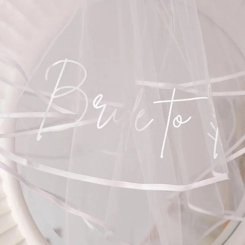 White tulle veil with 'Bride to Be' lettering and gathered sheer edge