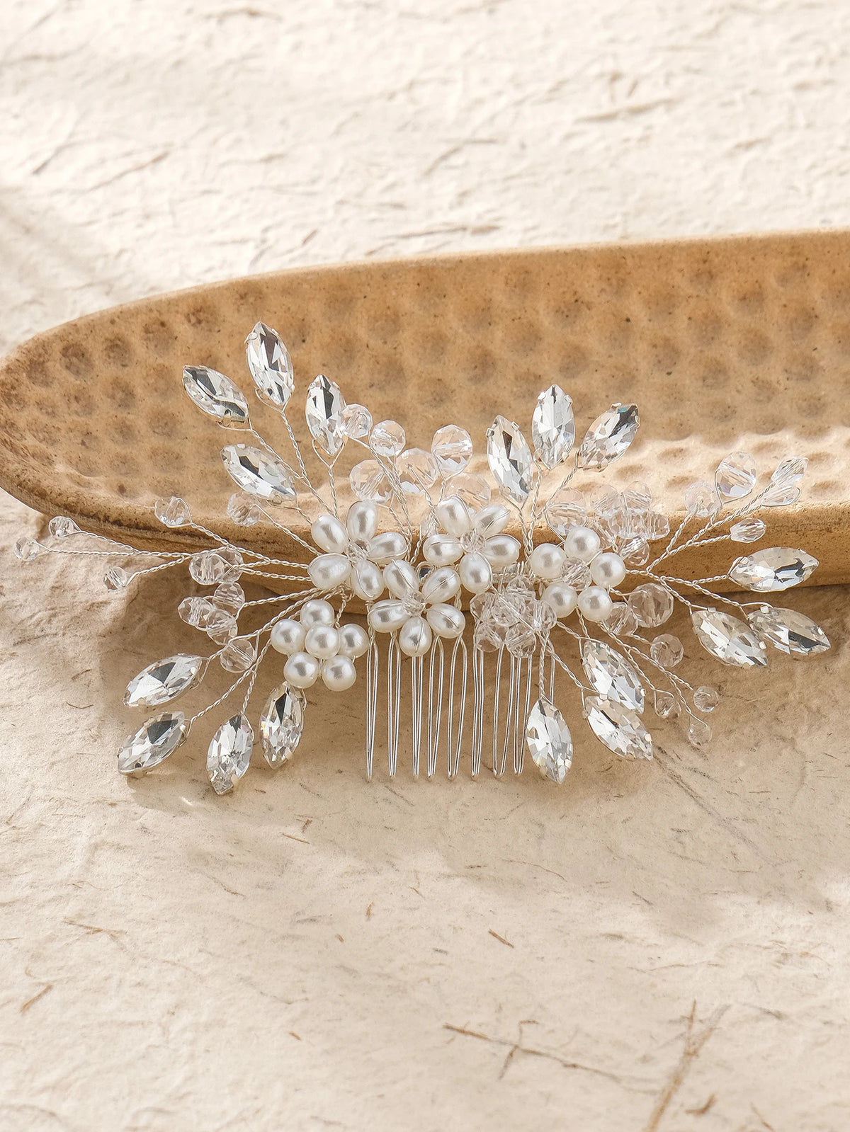 Bridal hair comb with pearl clusters, crystal leaf accents, and clear jeweled comb tines