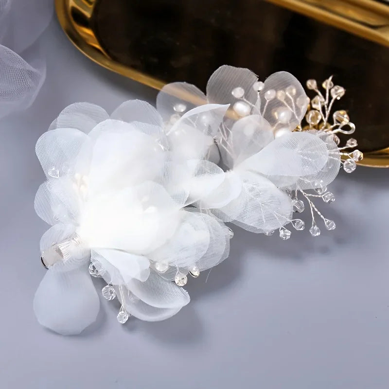 Silver bridal hair clip with sheer organza flower blooms and crystal spray