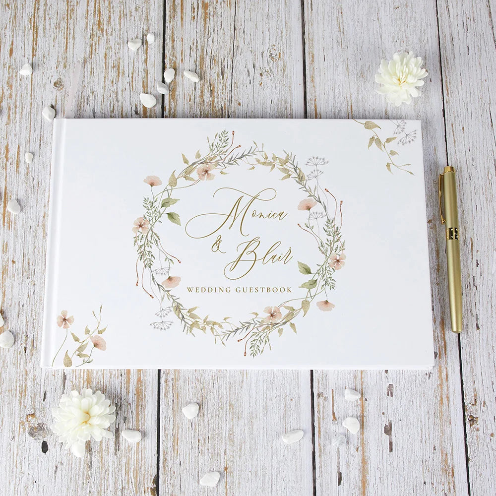 Wedding guest book with floral wreath cover and personalized names, white with gold details