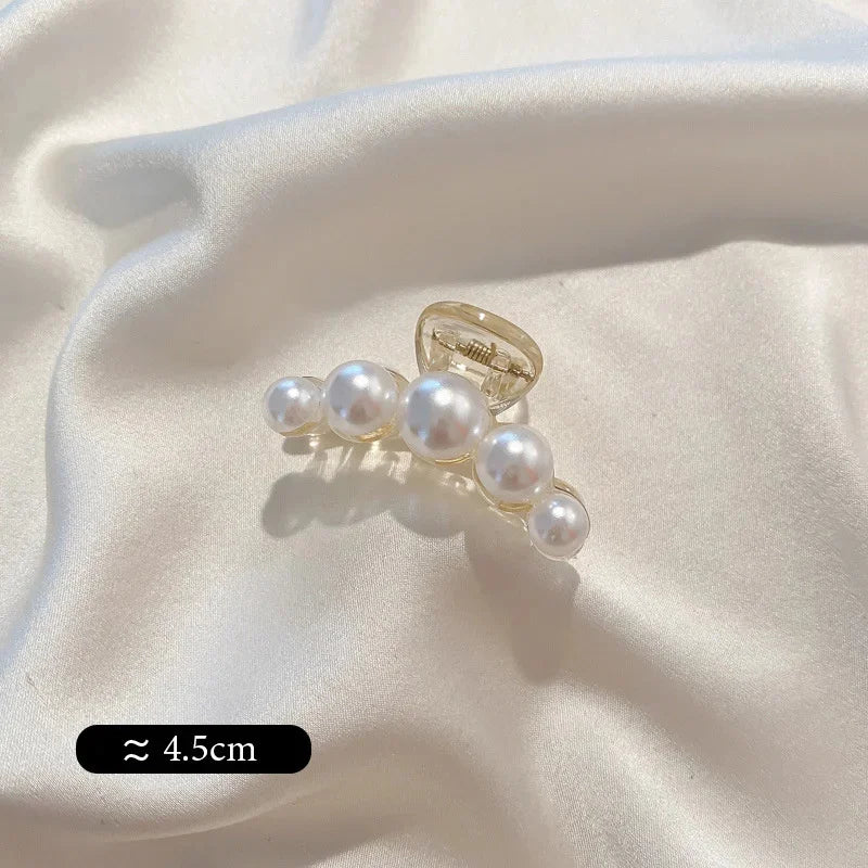Small pearl bead hair claw clip with three round faux pearls and clear prongs