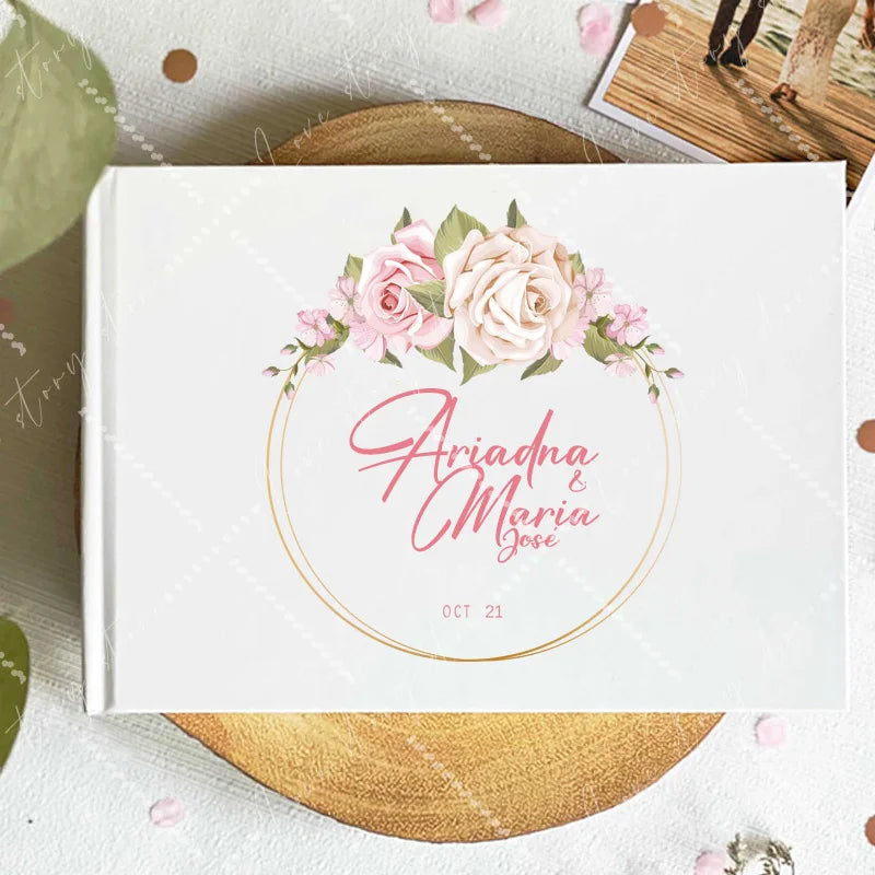 Wedding guest book cover with pink rose wreath and circular gold frame; names and date Oct 21