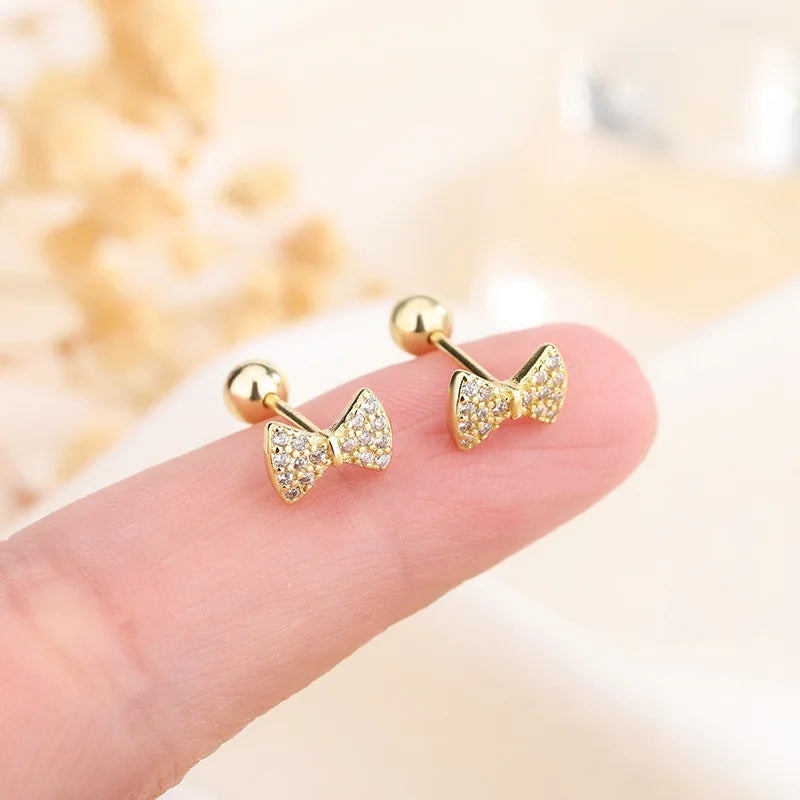 Gold bow stud earrings with clear crystal accents