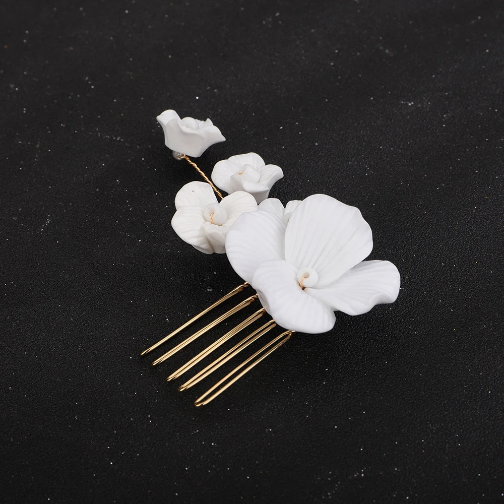 White orchid blossom bridal hair comb with small flowers and silver-tone prongs